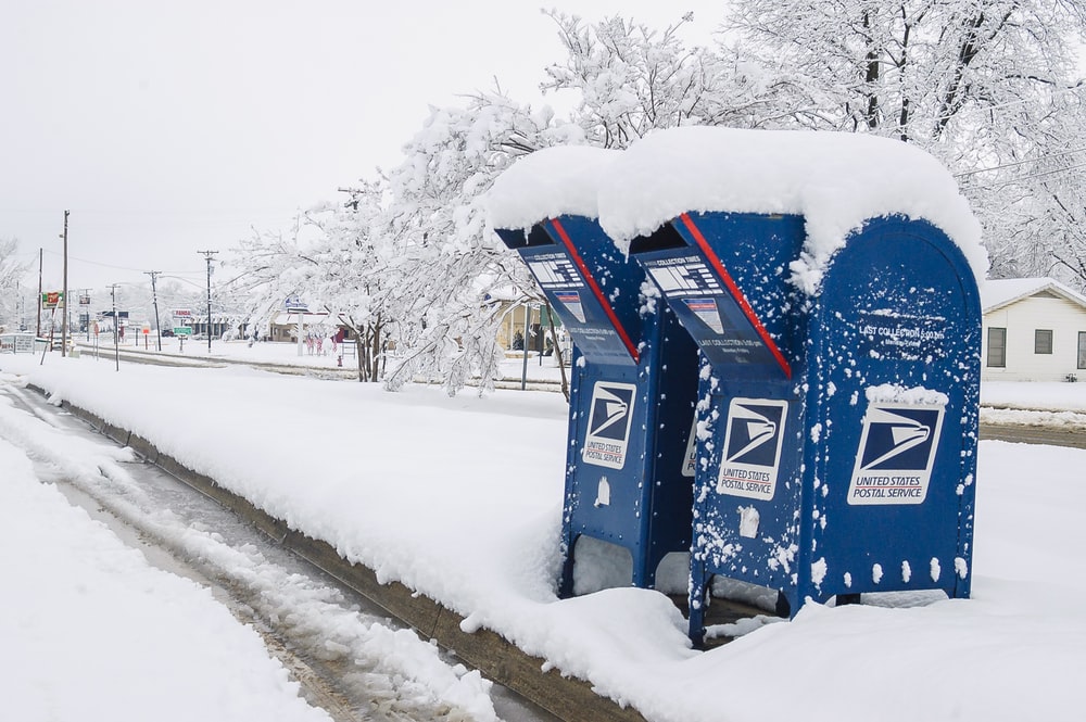 two blue-and-white mail boxes