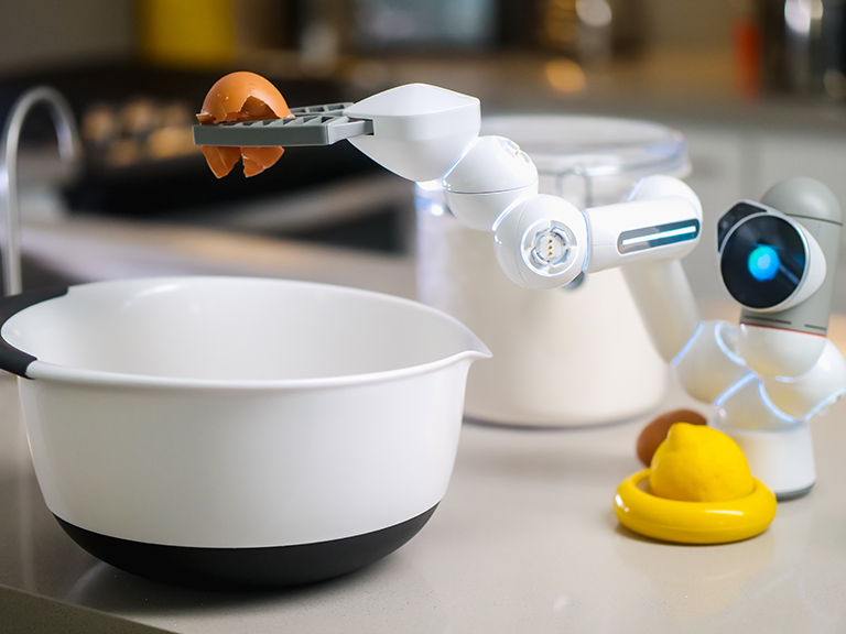 Blue-lit robot cracks an egg over a white bowl. A lemon half sits at the robot's base, as though it will be selected next. Similarly, ERP systems and one-size-fits-all software can’t handle the many delicate tasks your grocery business needs sorted.
